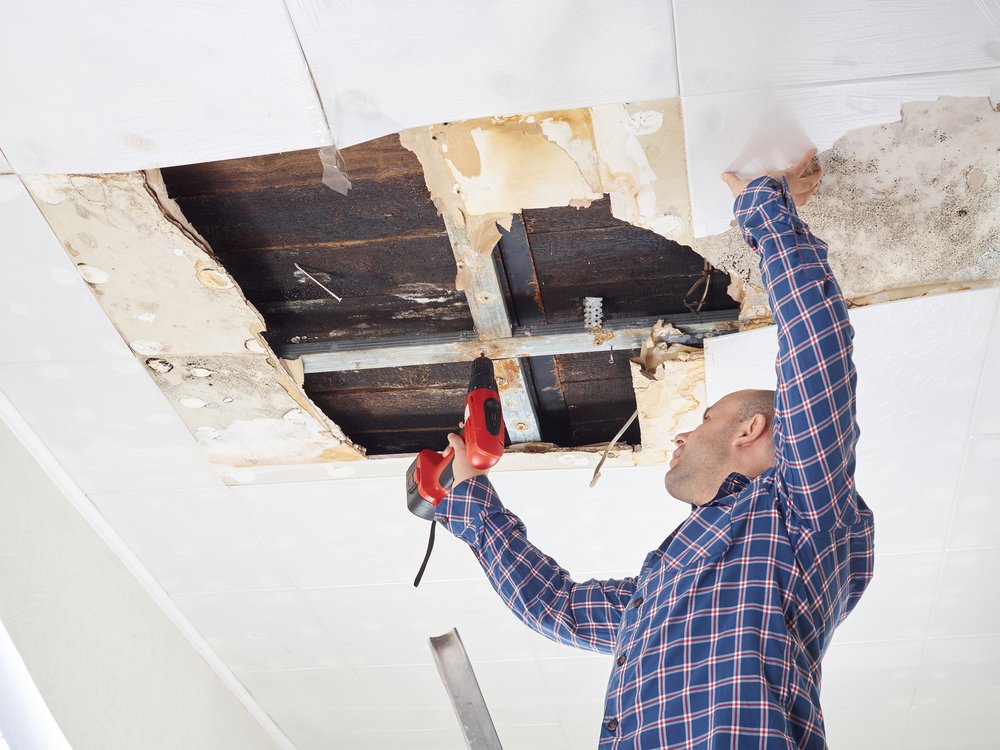 service-3 man,repairing,collapsed,ceiling.,ceiling,panels,damaged,huge,hole,in